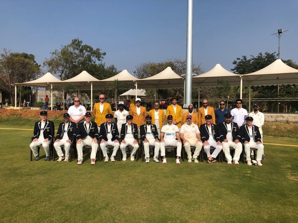 Touring club side and Indian host club in blazers, team photo before a match in India